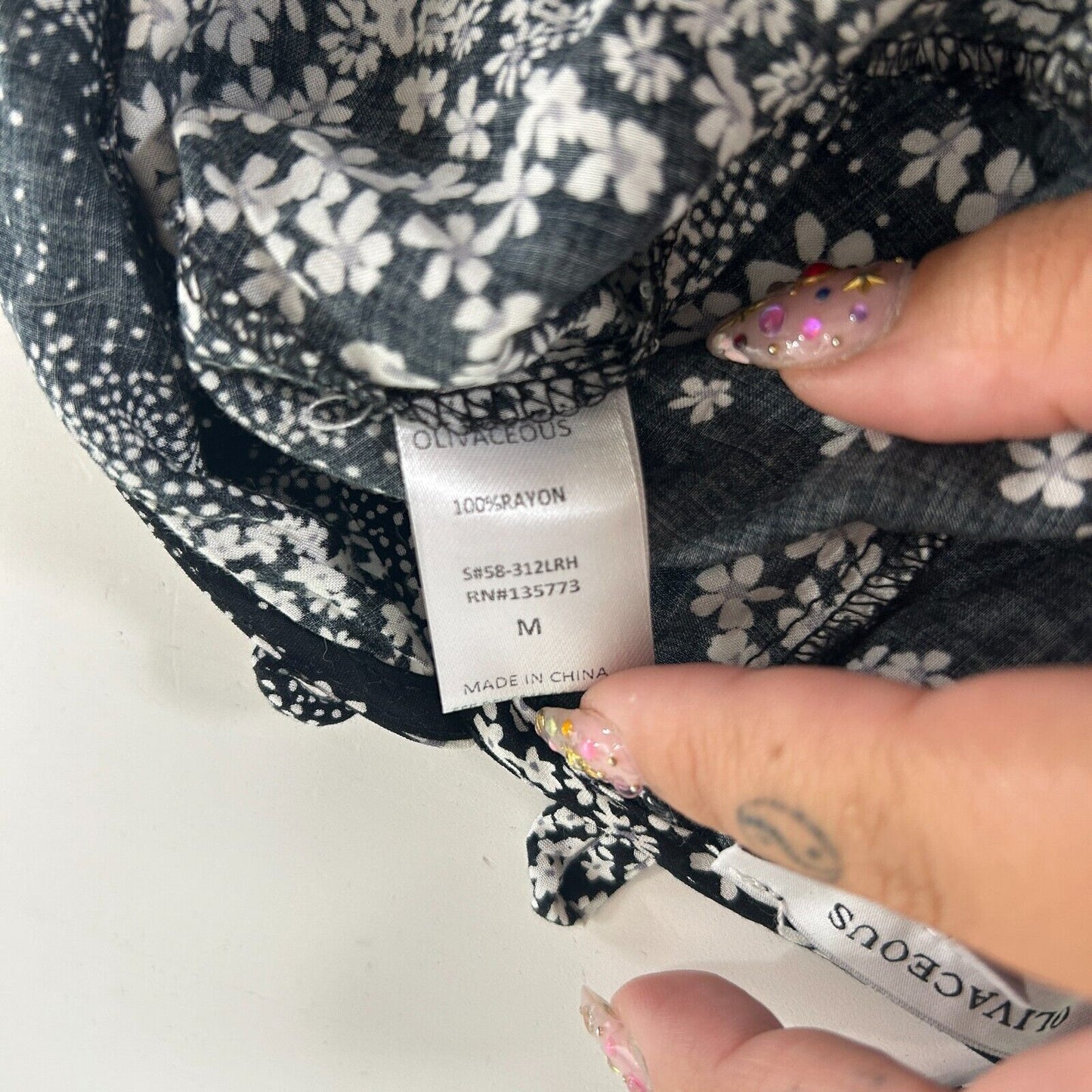 Olivaceous Black and White Floral Halter Tie Neck Open Back Flowy Romper Medium