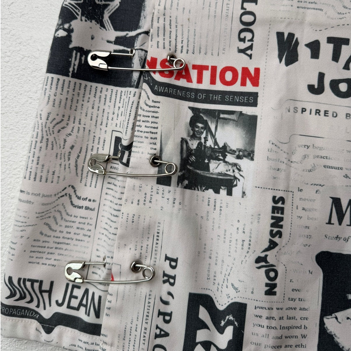 With Jéan Ivory Newspaper Print Safety Pin Mini Skirt