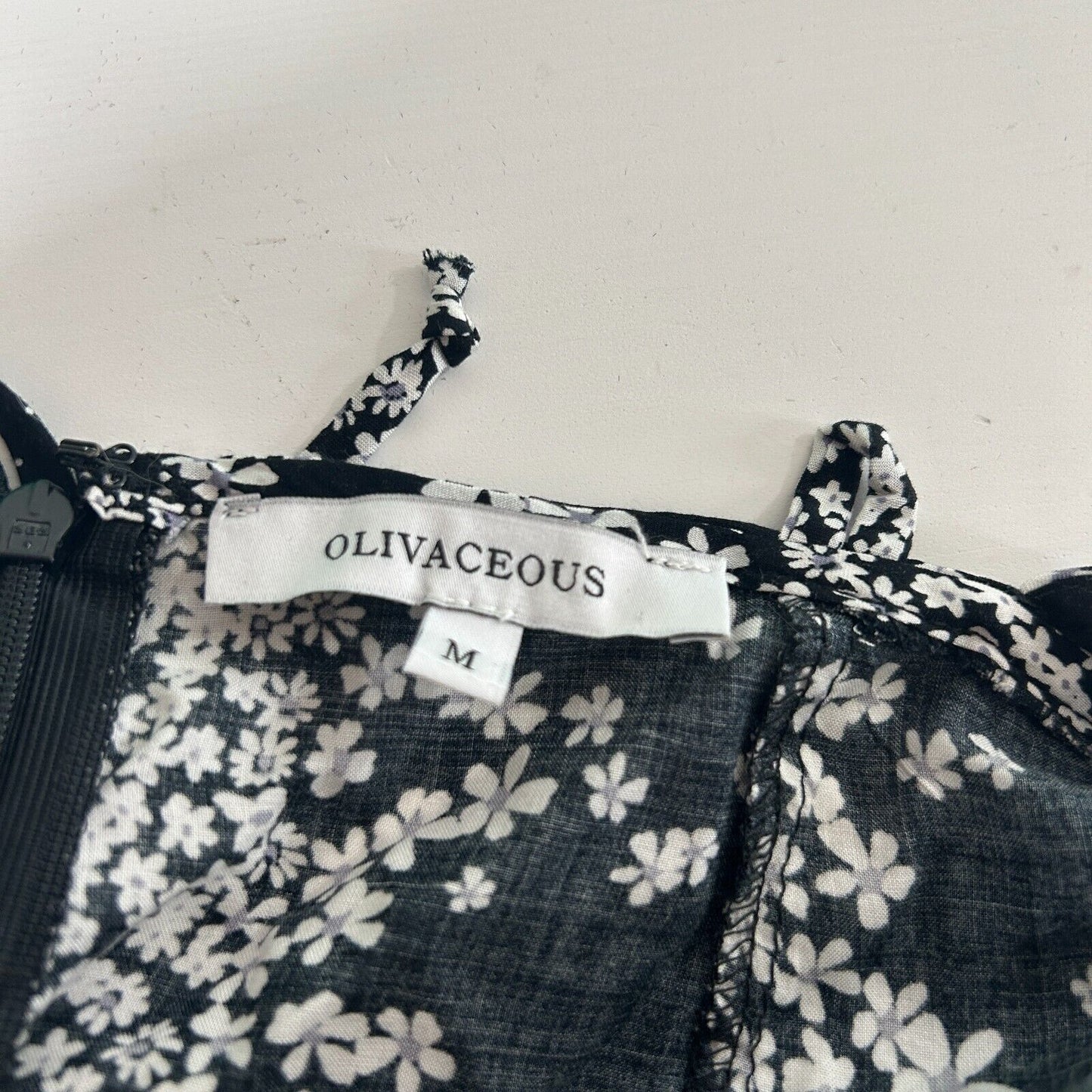 Olivaceous Black and White Floral Halter Tie Neck Open Back Flowy Romper Medium