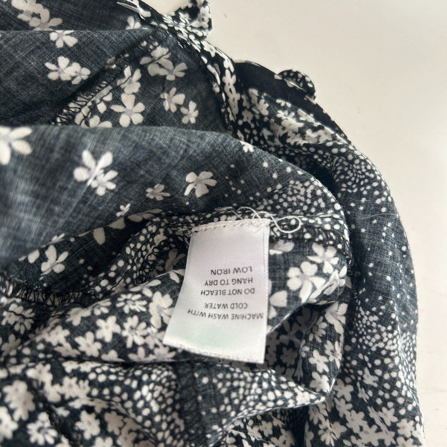 Olivaceous Black and White Floral Halter Tie Neck Open Back Flowy Romper Medium
