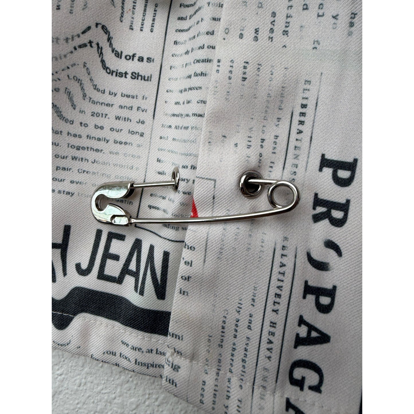 With Jéan Ivory Newspaper Print Safety Pin Mini Skirt