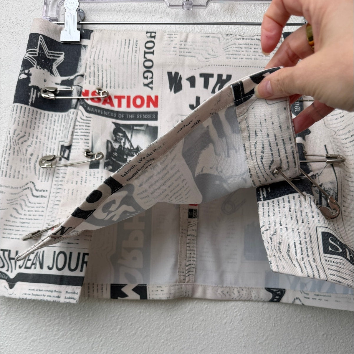 With Jéan Ivory Newspaper Print Safety Pin Mini Skirt